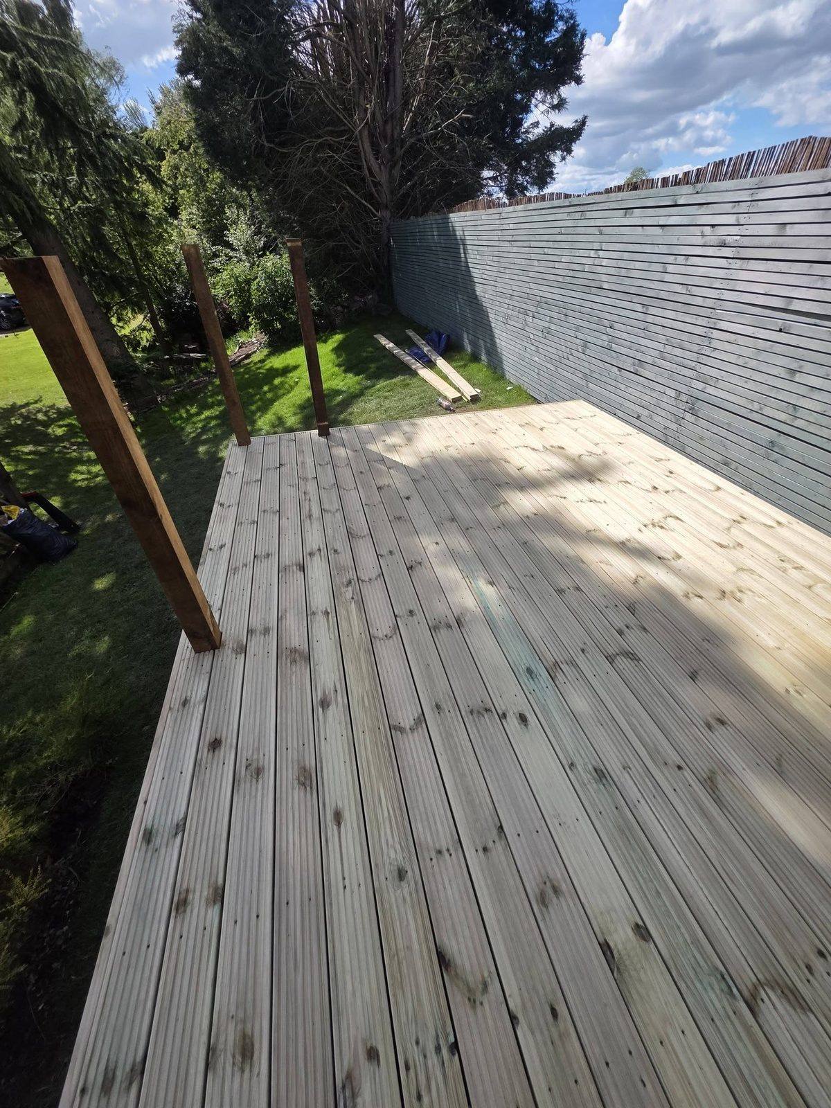 Timber decking project with fence backdrop