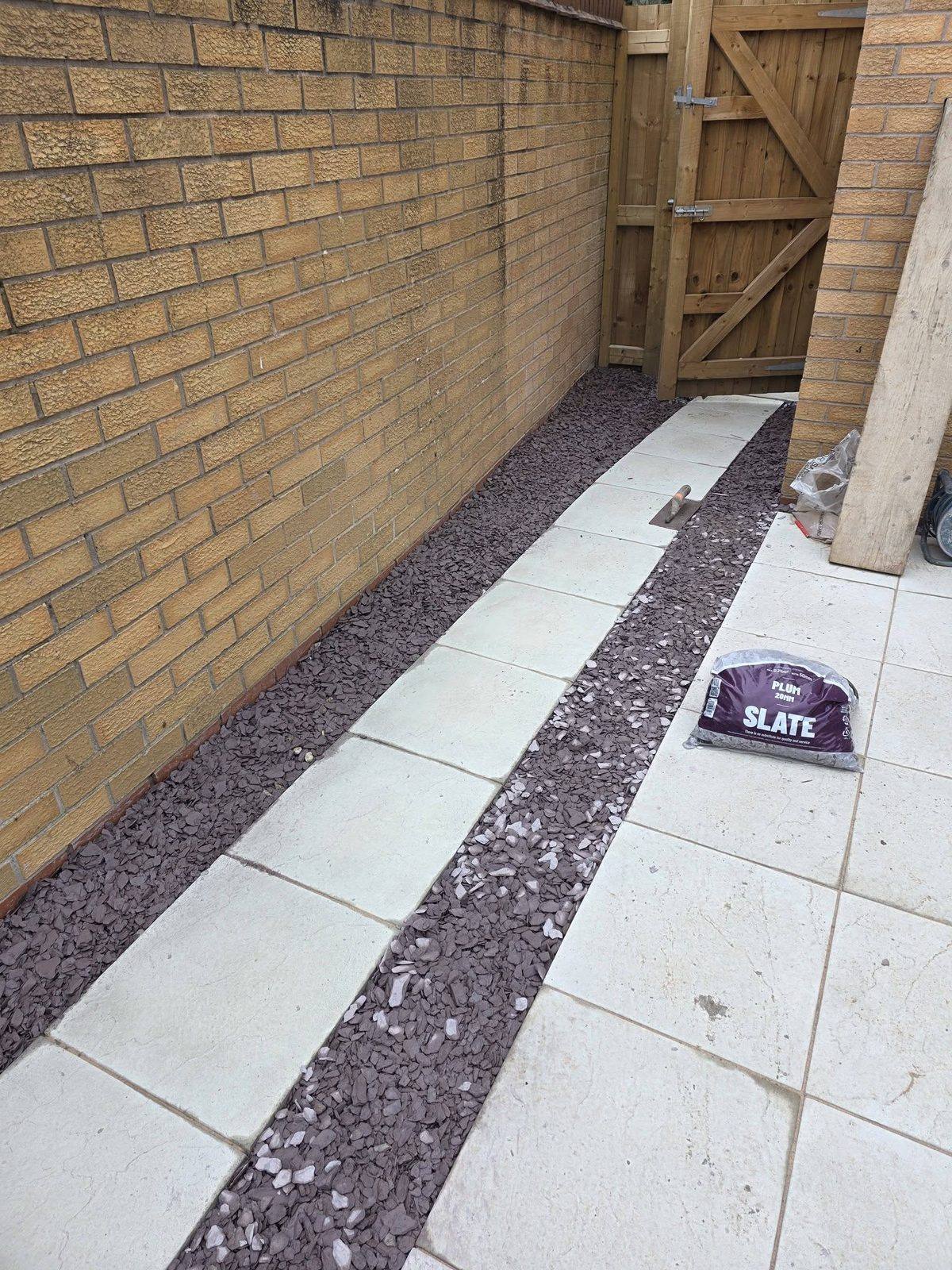 Paved patio pathway with slate chipping border