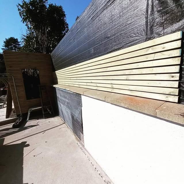 New fascia boards being fitted along a roofline