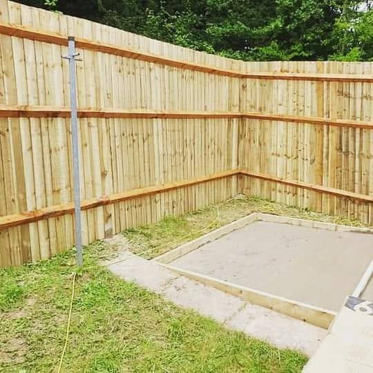 Newly installed timber fence panels along a garden corner
