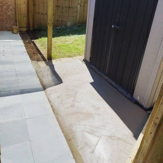 A neatly laid paved pathway alongside a property