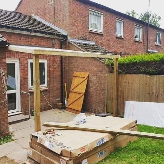 Timber pergola frame being built over a seating area